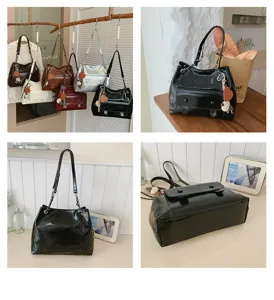 Vintage patent leather shoulder tote bag with metal chain strap and cute heart charm detail.
