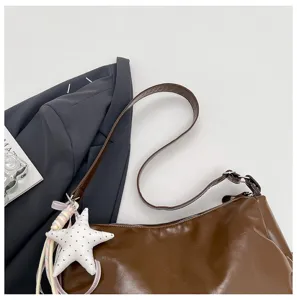 Brown vintage shoulder bag detail view, stylish PU leather crossbody bag with cute star charm.