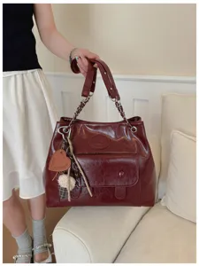 Retro dark red leather tote bag for women, large capacity shoulder bag with chic chain strap.