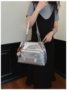 Stylish silver metallic shoulder bag for women, retro chain tote bag with front pocket.
