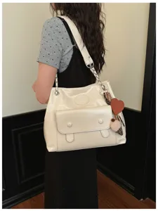 Chic white shoulder bag detail, large capacity design with chain strap and lovely heart charm.