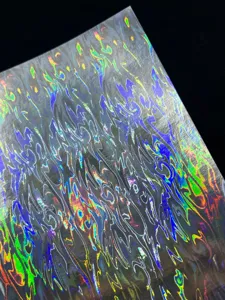 Holographic laser cardstock detail showcasing iridescent flame pattern for crafts and badges.