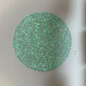 Iridescent glitter badge backing paper detail shot, showing sparkling art paper texture for pins.