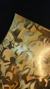 Golden metallic water ripple special paper detail shot, perfect for badge backing and crafts.