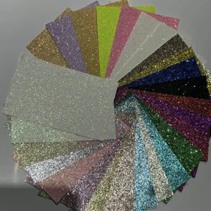 Close-up of colorful glitter paper sheets, sparkling craft cardstock details, vibrant textures.