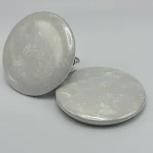 White ceramic special art paper round badge base paper detail, smooth pearlescent texture.