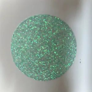 Holographic glitter badge backing paper detail, green sparkly special art paper for crafts.