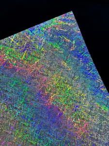 Close-up detail of holographic specialty cardstock with vibrant rainbow broken glass pattern.