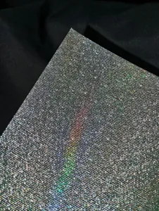 Holographic glitter badge backing paper detail, sparkling laser texture sheet for cards.