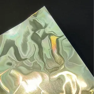 Holographic water ripple specialty paper for badge backing, shiny gold silver handmade crafting.