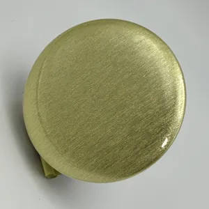 Gold glitter badge button detail shot, premium metallic textured anime merch accessory.