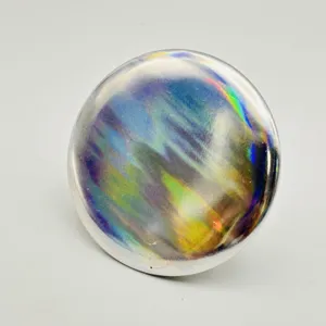 Holographic round metal badge peripheral accessory with vibrant rainbow laser light effect.