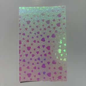 Holographic heart pattern badge film detail, shimmering laser sticker for DIY craft projects.