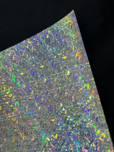 Close-up detail shot of holographic cardstock paper showing dazzling laser sparkle texture.