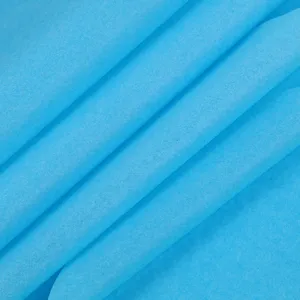 Detailed view of bright blue tissue paper showing soft texture and elegant folds for gifts.