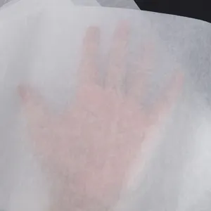 Detail view of translucent white tissue wrapping paper showing paper texture and light transmission.