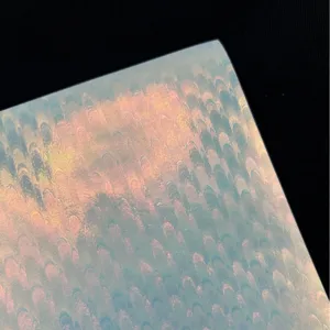 Macro detail shot showing the iridescent holographic glitter texture of the specialty badge paper.