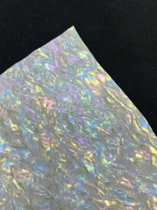 Close-up detail view of colorful silk series holographic specialty paper texture for badge making.