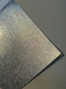Detailed close-up of colorful glitter flash specialty paper, showing fine sand texture.