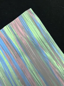 Detailed close-up view of colorful silk series shiny special paper for badge backing.