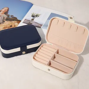 Portable PU leather jewelry box with ring rolls and necklace hooks for travel and home.