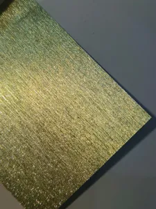 Glitter specialty paper texture detail, fine brushed golden surface for handmade crafts.