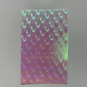 Detailed view of holographic badge backing paper, featuring fine laser flash texture.