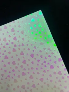 Detail view of holographic glitter specialty paper featuring cute heart pattern for DIY crafts.