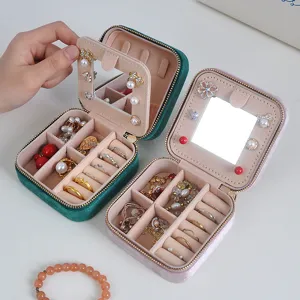Velvet portable travel jewelry box with mirror, ring organizer and multi-compartment storage.