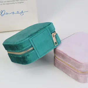 Portable velvet jewelry box with secure metal zipper, perfect for rings and earrings.