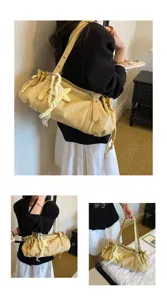 Detailed view of stylish pleated yellow shoulder bag, offering large capacity for daily commuting.
