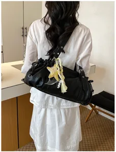Black pleated shoulder bag detail view, casual hobo tote bag with star charm and strap.