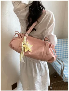 Stylish pink pleated shoulder bag for women, large capacity vintage commuter tote bag detail.