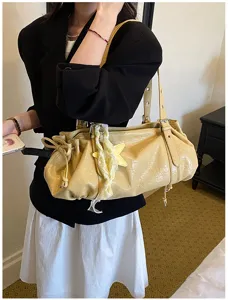 Detailed view of women's pleated retro underarm tote bag in yellow, stylish everyday chic.