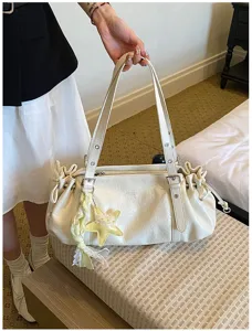 Detailed view of the stylish pleated commuting tote bag with cute star charm and vintage design.