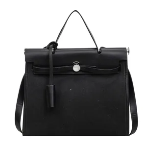 Sac a main Kelly en toile et cuir noir classique poignee superieure bandouliere
