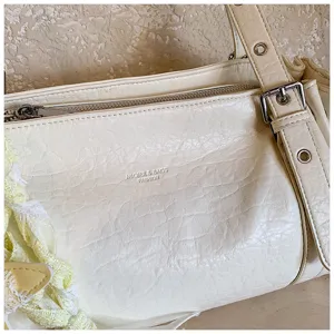 Vintage crinkled leather shoulder bag for women, stylish underarm tote bag for daily commute.