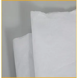 Close-up detail of white tissue wrapping paper showing fine texture and translucent quality.