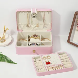 Pink double layer PU leather jewelry box with lock, multiple compartments for rings and earrings.