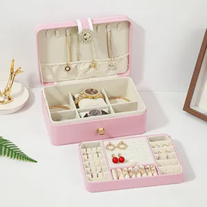 Pink double layer PU leather jewelry box with compartments for rings, earrings, and necklaces.