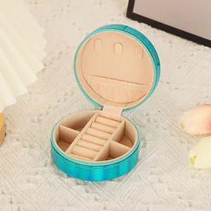 Portable round PU leather jewelry box with zipper, ring slots and multi-compartment storage.