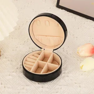 Portable round PU leather jewelry box with soft velvet lining and multiple practical compartments.
