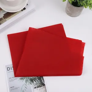 Red tissue paper detail showing thin texture and vibrant color for gift wrapping and flower packing.
