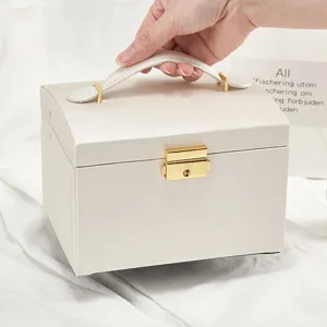 White PU leather jewelry box with handle and lock, large capacity travel storage case.