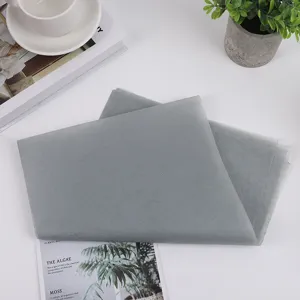 Grey tissue paper for gift box packaging, clothing and flower wrapping detail view.