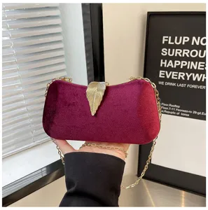 Burgundy velvet evening clutch bag with gold leaf clasp and chain strap for women party dress.