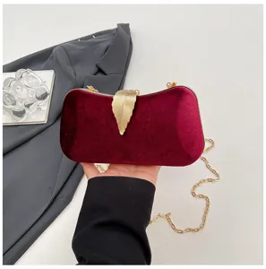 Red velvet evening clutch bag with gold leaf clasp and chain strap for party and wedding.