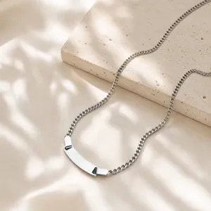 Close-up of stainless steel curb chain with blank curved ID plate in polished silver finish.