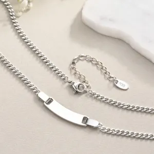 Stainless steel curb chain necklace with blank curved ID plate, detail shot showing texture and extension.