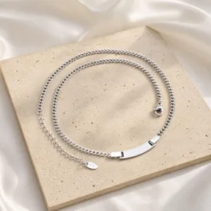 Stainless steel curb chain necklace with a blank curved ID tag in steel color for custom engraving.